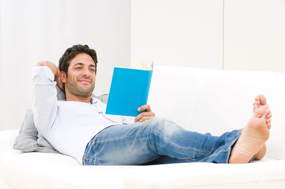image of single man reading a book