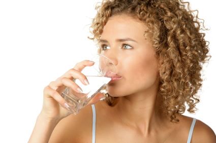 image of young women drinking a glass of water